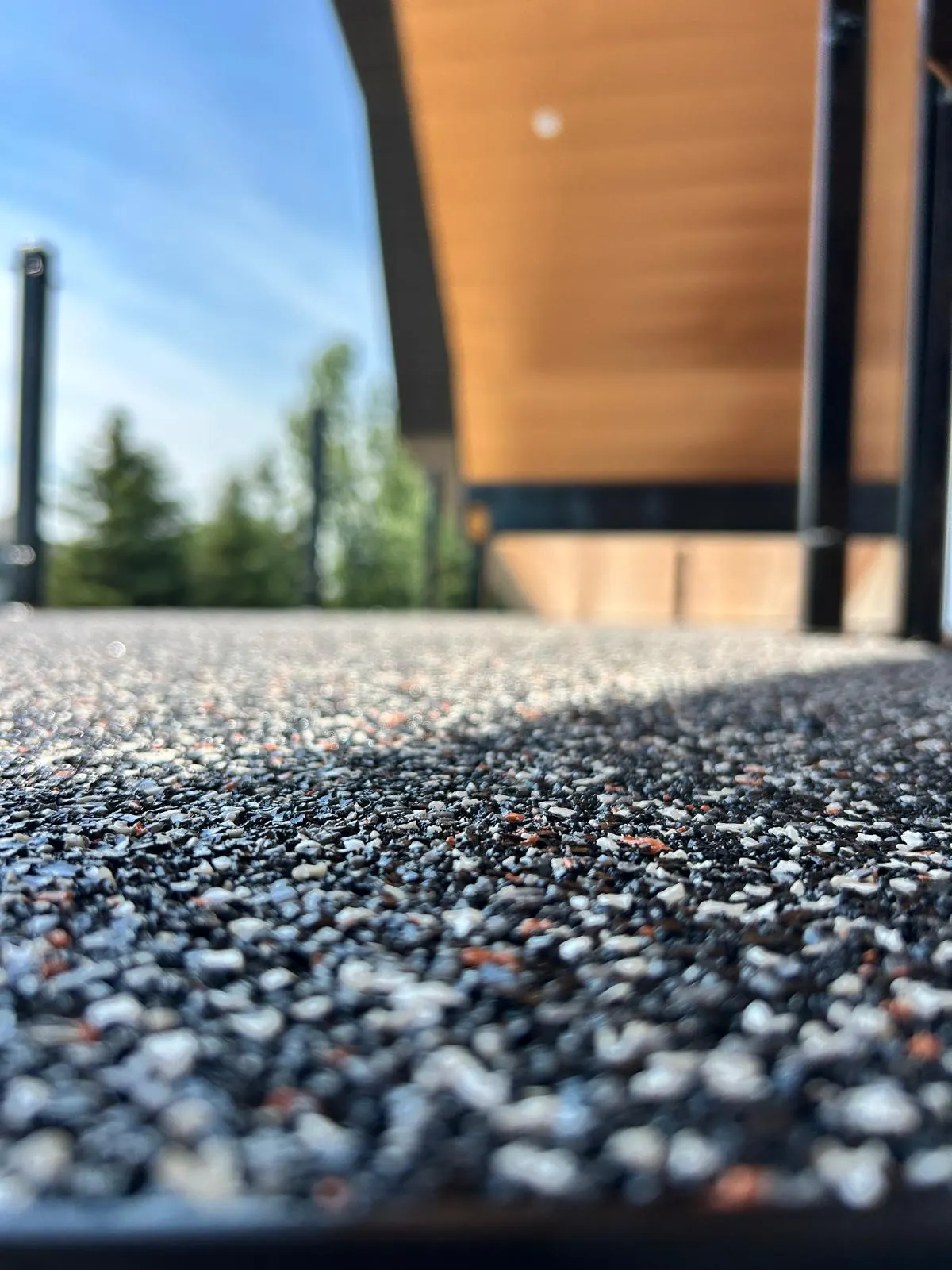 Close-up of a poured rubber stair tread showing the granule blend